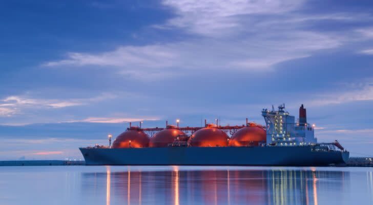 Large tanker ship carrying natural gas at dusk in harbor