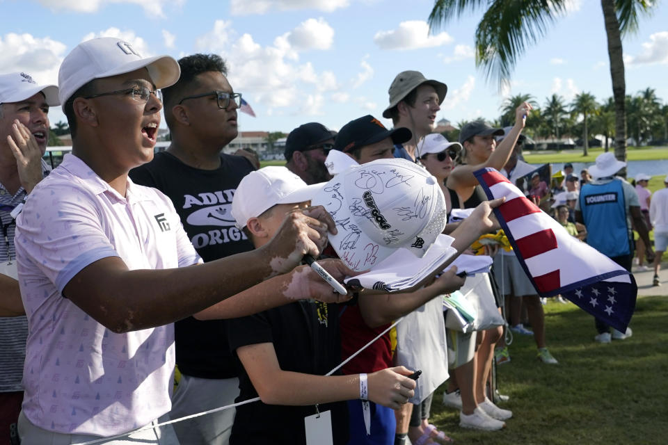 Fans call out for autographs as Cameron Smith walks from the 8th hole during the first round of the LIV Golf Team Championship at Trump National Doral Golf Club, Friday, Oct. 28, 2022, in Doral, Fla. (AP Photo/Lynne Sladky)