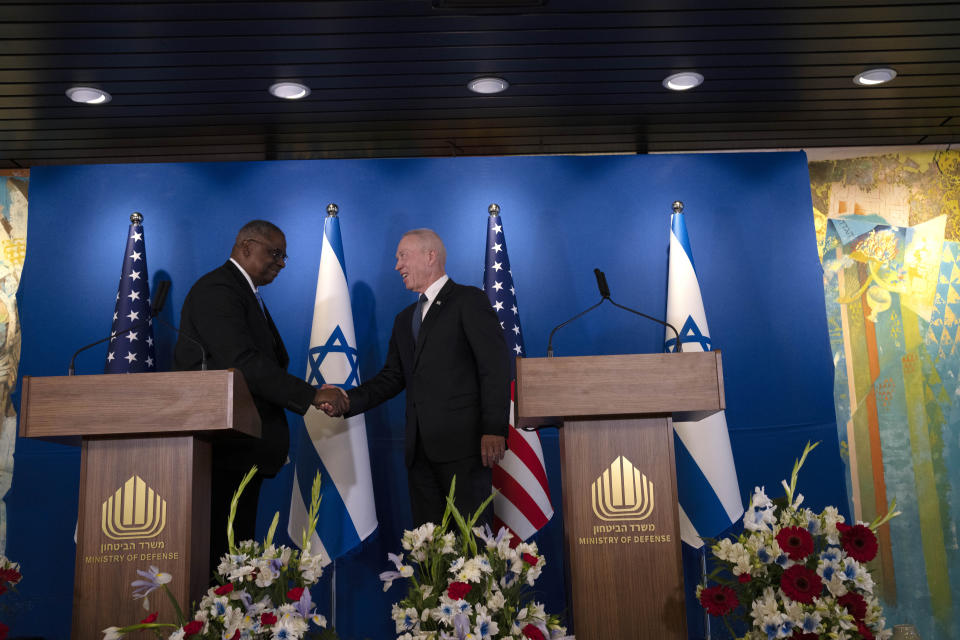 U.S. Secretary of Defense Lloyd Austin, left, shakes hands with his Israeli counterpart, Minister of Defence Yoav Gallant at a joint statement following their meeting at Ben Gurion International Airport in Thursday, March 9, 2023. (AP Photo/Maya Alleruzzo)