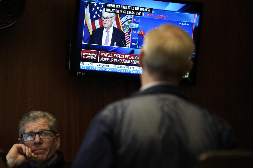 FILE - Traders on the floor at the New York Stock Exchange watch Federal Reserve Chair Jerome Powell's news conference after the Federal Reserve interest rate announcement in New York, Wednesday, Feb. 1, 2023. Over the past year, the Fed has raised its key short-term rate eight times, causing many kinds of consumer and business loans to become more expensive.(AP Photo/Seth Wenig, File)