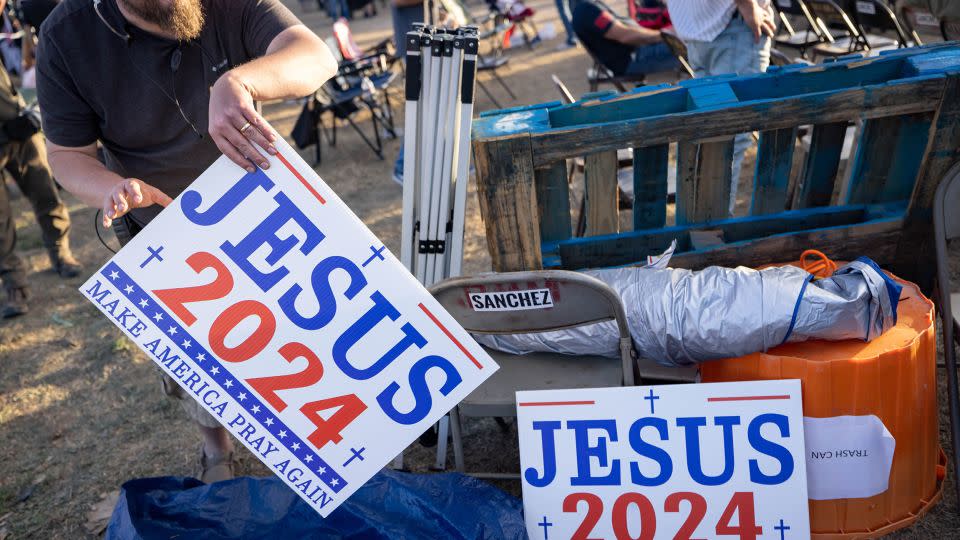 A man takes a "Jesus 2024" sign at the Cornerstone Children's Ranch during the "Take Our Border Back" convoy rally on February 3, 2024, in Quemado, Texas. - Michael Nigro/Sipa