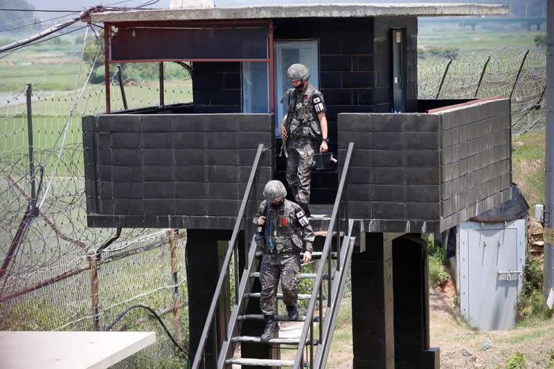 South Korean soldiers walk down from their guard post near the demilitarized zone separating the two Koreas in Paju