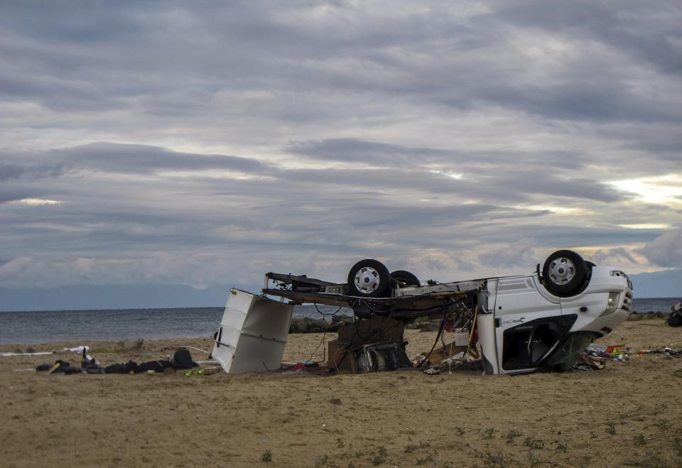 An overturned vehicle is seen on a beach at Sozopoli village in Halkidiki region, northern Greece on Thursday, July 11, 2019. Two people were killed when high winds overturned their recreational vehicle. A powerful storm hit the northern Halkidiki region late Wednesday. (Giannis Moisiadis/InTime News via AP)