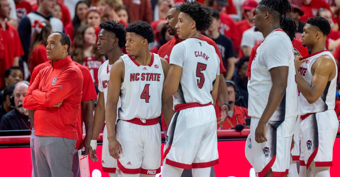 N. C. State coach Kevin Keatts and his team await the review of play late in the second half against North Carolina on Sunday, February 19, 2023 at PNC Arena in Raleigh, N.C.