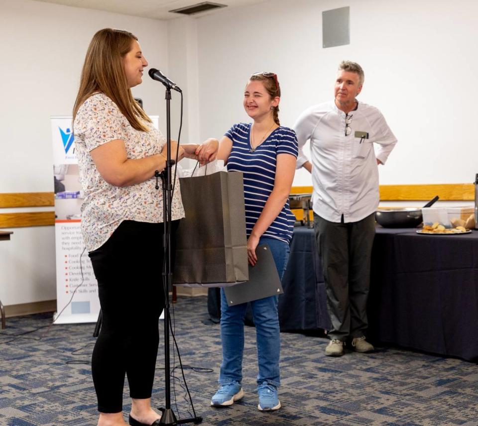 Alix Rhoads is awarded by divisional program manager, Kailey Baer, for perfect attendance during the 12-week program