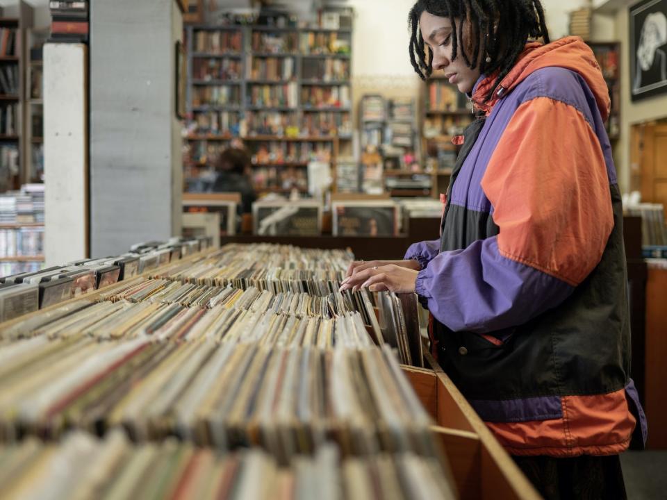 A woman searches for vinyl records to purchase.