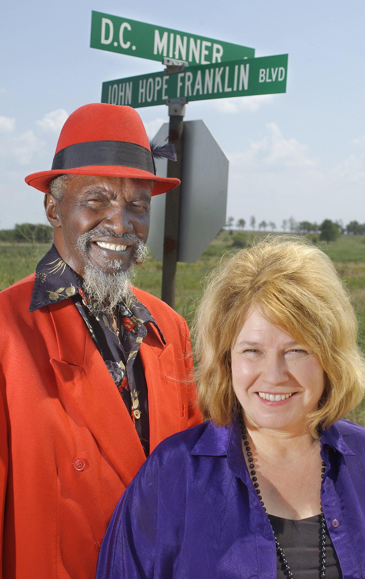 Husband-and-wife blues singers D.C. Minner and Selby Minner stand beneath a street sign in Rentiesville that honors him near his home in 2003. Since D.C. died in 2008, his widow has continued his legacy of bringing the blues to Rentiesville.
