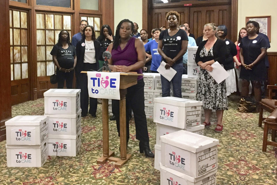 FILE - In this May 29, 2018, file photo, Danielle Atkinson, a member of the Michigan Time to Care group that submitted signatures for a ballot initiative to mandate earned paid sick time, speaks in support of the measure at the Central United Methodist Church in Lansing, Mich. The Michigan Court of Appeals struck down key changes to the state's ballot drive law on Monday, Jan. 27, 2020. The ruling was the second in fourth months to negate much of the law that was enacted by Republican-led Legislature and then-Gov. Rick Snyder in a contentious lame-duck session in 2018. (AP Photo/Alice Yin, File)