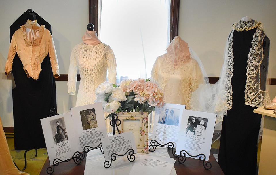 Some of the wedding dresses on display at the "Wedding Dress Retrospective" exhibit at the Handy House in Westport.