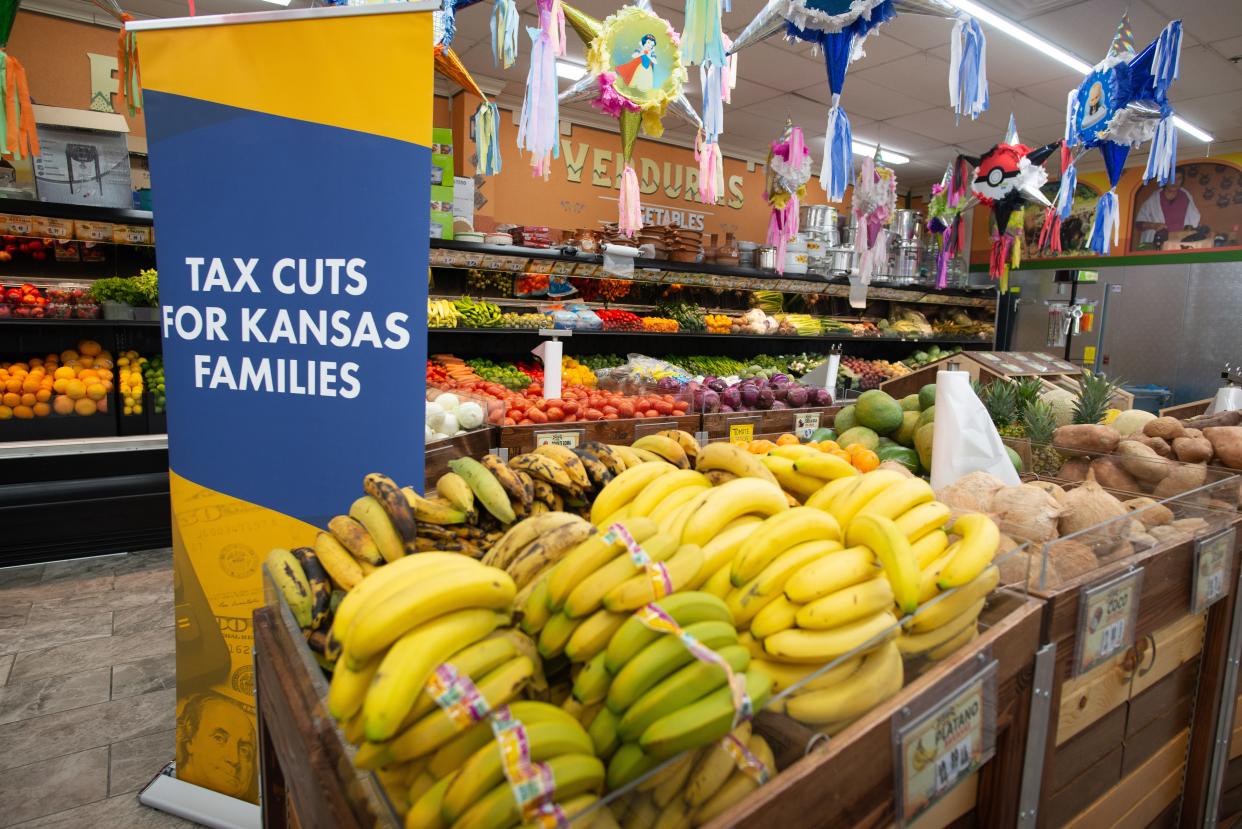 A banner promoting the food sales tax bill is displayed within the produce section of Mi Pueblito Meat Market in Topeka during a ceremonial bill signing event in June. The food sales tax cut is technically law now, but won't take effect until Jan. 1.