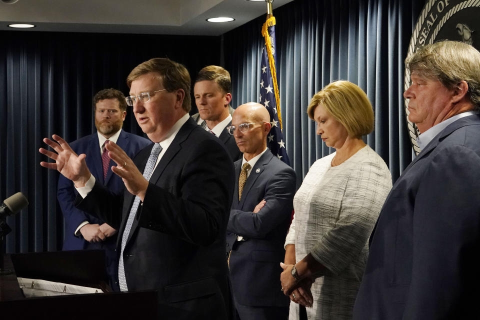 Mississippi Gov. Tate Reeves, second from left, announces a proposal that he says should alleviate financial problems for hospitals during a news conference Thursday, Sept. 21, 2023, in Jackson, Miss. (AP Photo/Rogelio V. Solis)