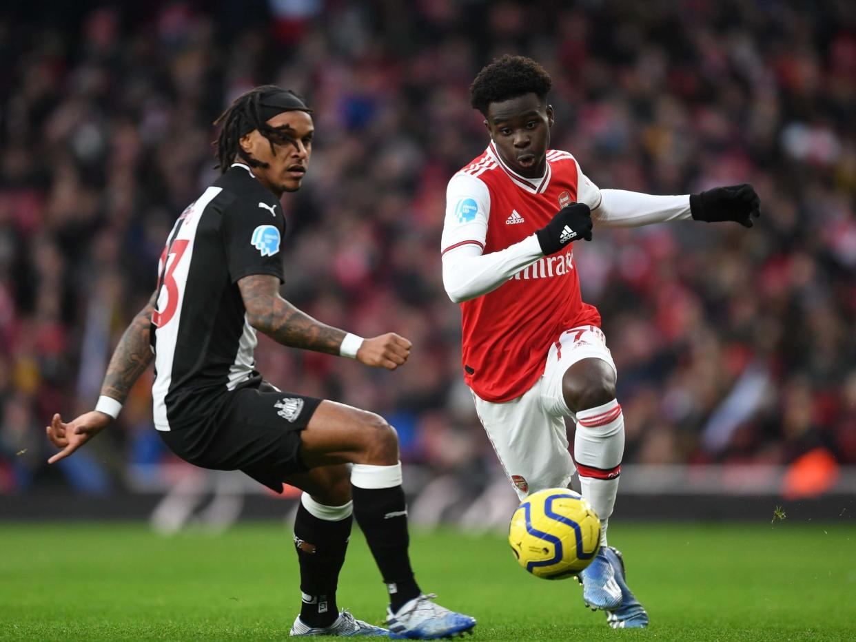 Bukayo Saka of Arsenal takes on Valentino Lazaro of Newcastle: Arsenal FC via Getty Images