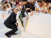 File - Actor Joaquin Phoenix signs autographs upon arrival at the premiere of the film 'Joker' at the Venice Film Festival. The 77th Venice Film Festival will kick off on Wednesday, Sept. 2, 2020, but this year's edition will be unlike any others. Coronavirus restrictions will mean fewer Hollywood stars, no crowds interacting with actors and other virus safeguards will be deployed. (Photo by Arthur Mola/Invision/AP, File)