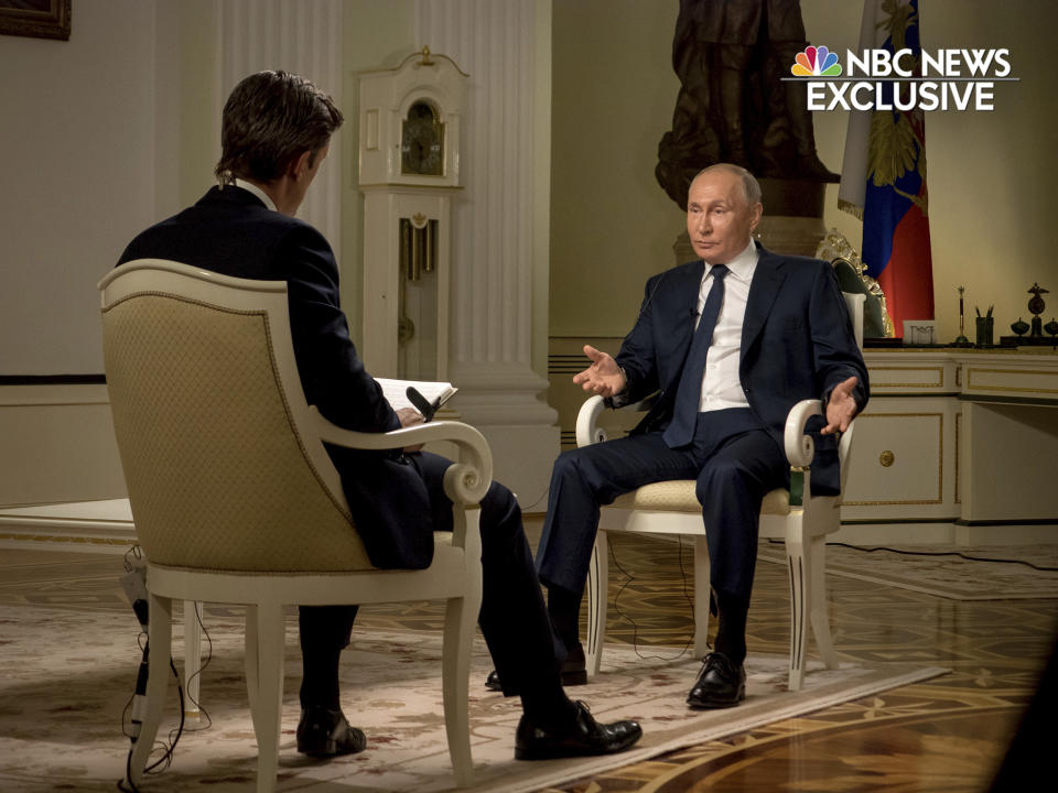 In this image provided by NBC News, journalist Keir Simmons, left, speaks with Russian President Vladimir Putin in an interview aired on Monday, June 14, 2021, two days before the Russian leader is to meet U.S. President Joe Biden in Geneva. Putin has sharply dismissed allegations that his country is carrying out cyberattacks against the United States as baseless. (NBC News via AP)