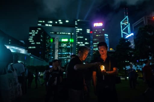 People light up candles at a memorial event in Hong Kong to mark the first anniversary of the death of late Chinese Nobel dissident Liu Xiaobo