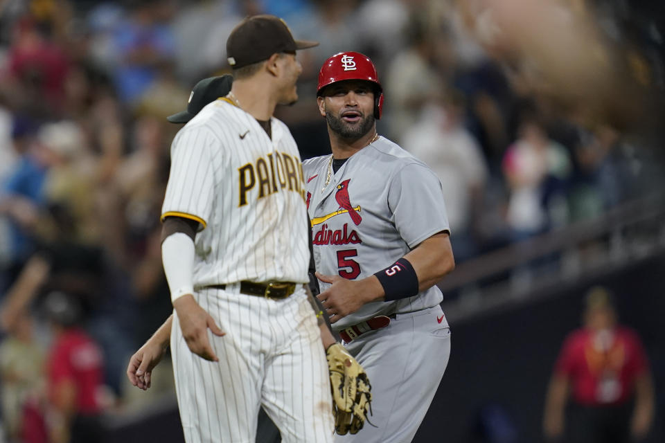 San Diego Padres third baseman Manny Machado, left, jokes with St. Louis Cardinals' Albert Pujols after the Padres' 5-0 win in a baseball game Tuesday, Sept. 20, 2022, in San Diego. (AP Photo/Gregory Bull)