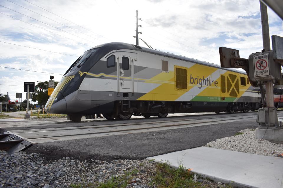 A northbound Brightline train carrying passengers from Miami to Orlando crosses East State Road 60, where 19th Place becomes 20th Street, in Vero Beach, Fla., on Monday, Oct. 9, 2023, the day the high-speed rail carrier increased its Miami-to-Orlando service from 16 to 30 trains daily.