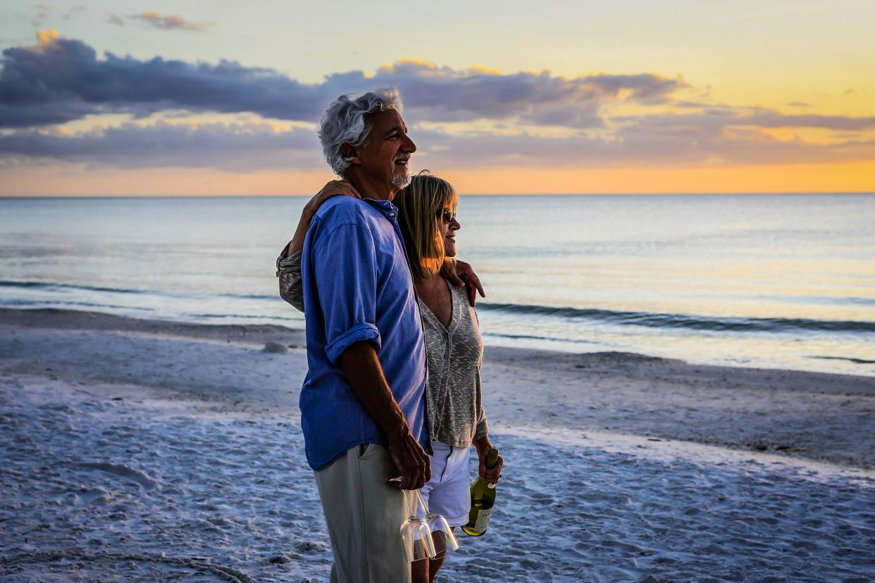 senior couple enjoying the sunset on Siesta Key Beach, Florida