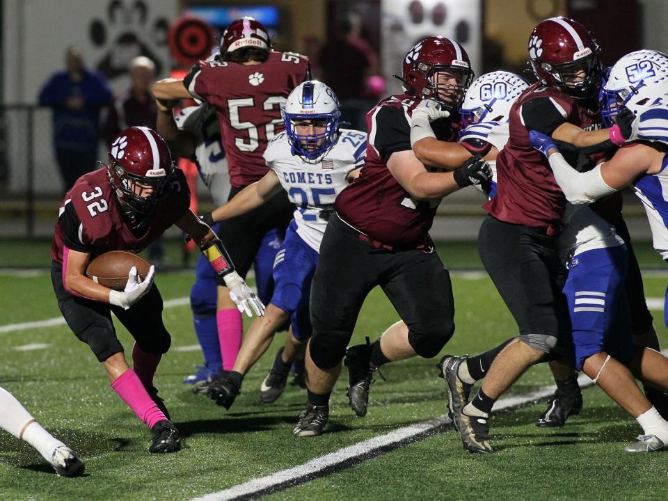 Newark's Kolton Peterson follows his blockers against Central Crossing on Friday.