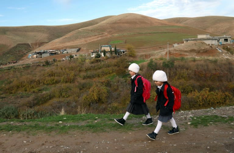 Young girls walk to school in the Iraqi Kurdish village of Sharboty Saghira, east of regional capital Arbil, on December 3, 2018