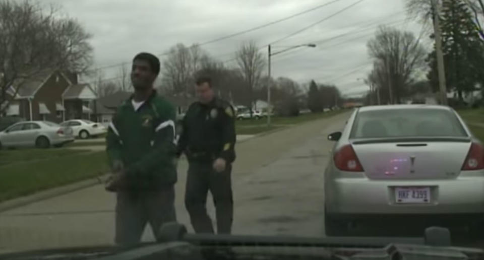 <span>John Kovach Jr leads Malakai Coleman away from his car informing him he’s going to jail</span>. Source: YouTube/ The Chronicle Telegram