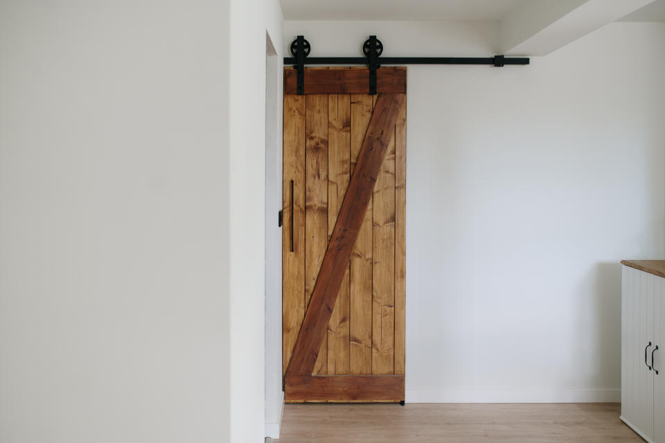 Sliding barn door in a clean, modern interior space