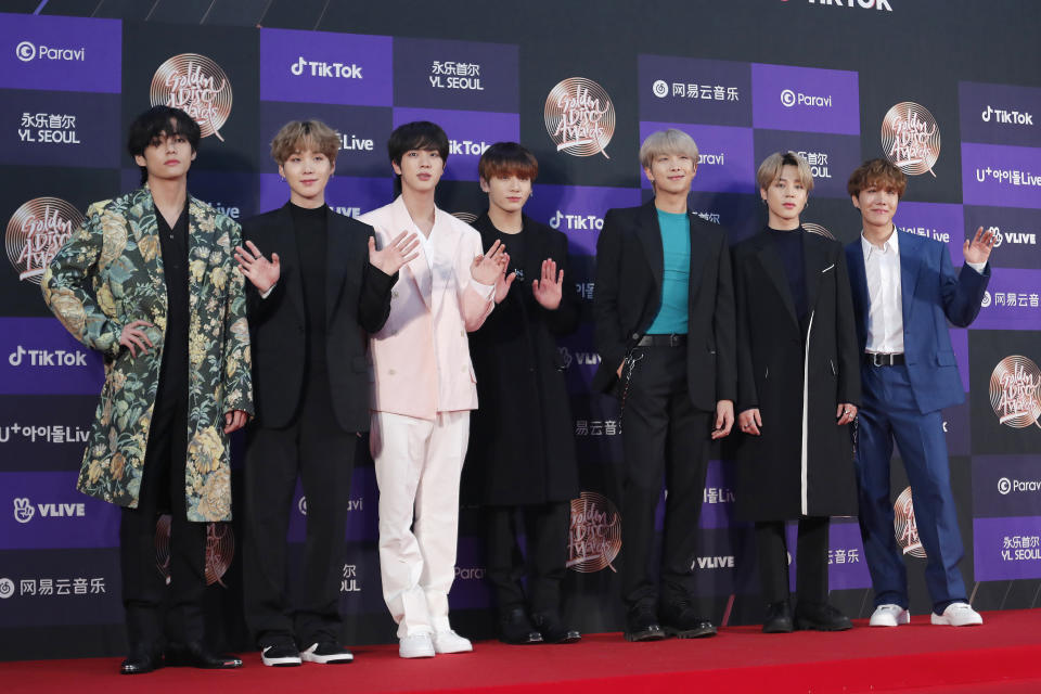 FILE - In this Jan. 5, 2020, file photo, members of South Korean K-Pop group BTS pose for photos during the Golden Disk Awards in Seoul, South Korea. BTS canceled a series of planned concerts in Seoul in April due to concerns about a soaring viral outbreak in South Korea, the band’s management agency said Friday, Feb. 28, 2020. (AP Photo/Ahn Young-joon, File)