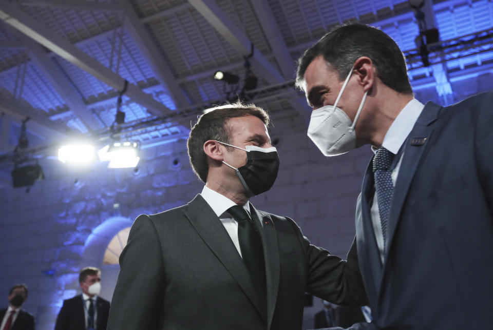 French President Emmanuel Macron, left, speaks with Spain's Prime Minister Pedro Sanchez during the opening ceremony of an EU summit at the Alfandega do Porto Congress Center in Porto, Portugal, Friday, May 7, 2021. European Union leaders are meeting for a summit in Portugal on Friday, sending a signal they see the threat from COVID-19 on their continent as waning amid a quickening vaccine rollout. Their talks hope to repair some of the damage the coronavirus has caused in the bloc, in such areas as welfare and employment. (AP Photo/Luis Vieira, Pool)