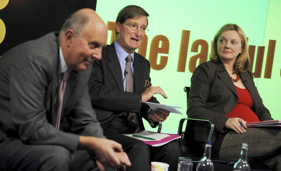 FILE - Conservative Shadow Home Secretary Dominic Grieve speaks at the launch Reform's Lawful Society report on the nature of crime and the incentives in the criminal justice system in London, with Elizabeth Truss, Deputy Director of Reform looking on, Sept. 1, 2008. Britain's new leader, Liz Truss, is the child of left-wing parents who grew up to be an admirer of Conservative Prime Minister Margaret Thatcher. Now she is taking the helm as prime minister herself, with a Thatcherite zeal to transform the U.K. One colleague who has known Truss since university says she is “a radical” who wants to “roll back the intervention of the state” in people’s lives, just as Thatcher once did. (Fiona Hanson/PA via AP, File)