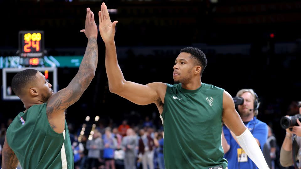 Antetokounmpo high-fives Lillard before the start of a preseason game against the Oklahoma City Thunder. - Sarah Phipps/AP