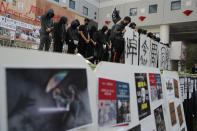 Protesters hold up the words "Missing Classmate Chow" at a makeshift memorial for the student who died, at the University of Science and Technology in Hong Kong on Friday, Nov. 8, 2019. Chow Tsz-Lok, a student from the University who fell off a parking garage after police fired tear gas during clashes with anti-government protesters died Friday, in a rare fatality after five months of unrest that intensified anger in the semi-autonomous Chinese territory. (AP Photo/Kin Cheung)