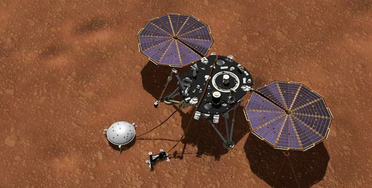 <span class="caption">Artist’s impression of InSight on the martian surface. The seismometer is under the white dome to the left of the landing platform.</span> <span class="attribution"><span class="source">NASA/JPLK-Caltech</span></span>