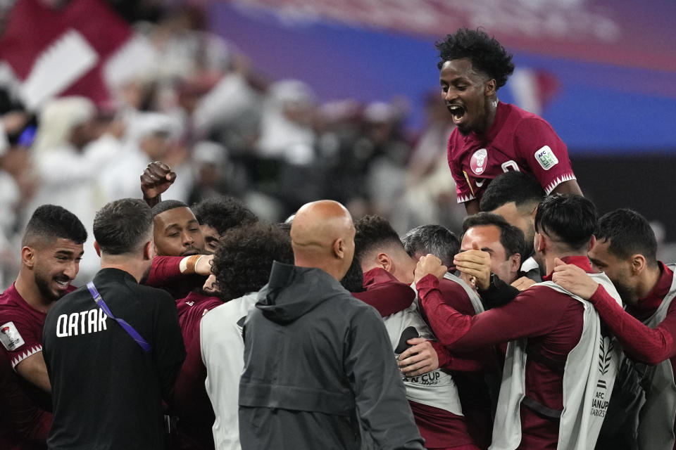 The team of Qatar celebrate after Akram Afif, not seen, scored a second goal during the Asian Cup semifinal soccer match between Qatar and Iran at Al Thumama Stadium in Doha, Qatar, Wednesday, Feb. 7, 2024. (AP Photo/Thanassis Stavrakis)