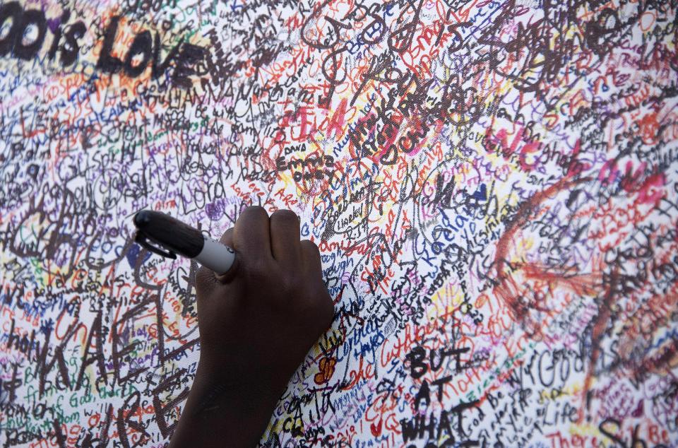 Hundreds of people signed  a condolence board outside Emanuel AME Church.