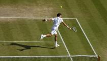 Serbia's Novak Djokovic in his match against Argentina's Juan Martin Del Potro during day eleven of the Wimbledon Championships at The All England Lawn Tennis and Croquet Club, Wimbledon.