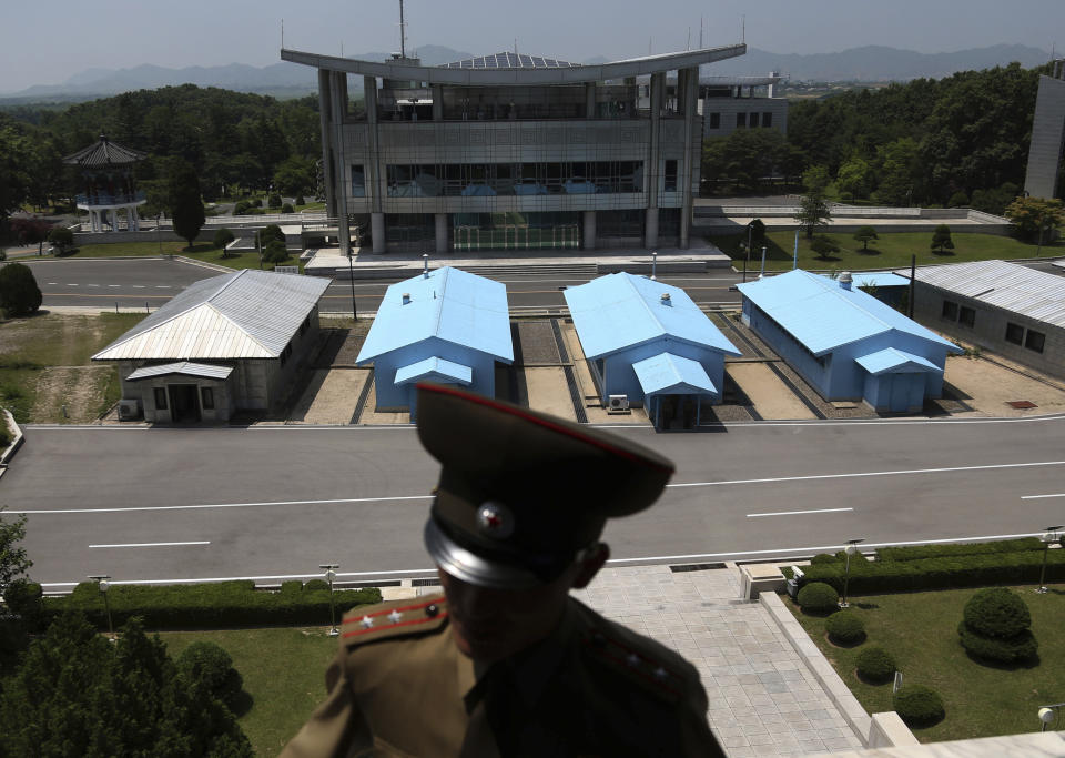 FILE - A South Korean building complex is seen in the background as North Korean soldiers guard the truce village at the Demilitarized Zone (DMZ) which separates the two Koreas in Panmunjom, North Korea on June 20, 2018. The truce that stopped the bloodshed in the Korean War turns 70 years old on Thursday, July 27, 2023 and the two Koreas are marking the anniversary in starkly different ways, underscoring their deepening nuclear tensions. (AP Photo/Dita Alangkara, File)