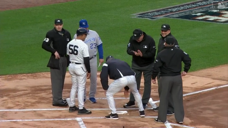 Joe Girardi cleaned the plate before Monday's game as a peace offering to the umps. (MLB.com Screenshot)