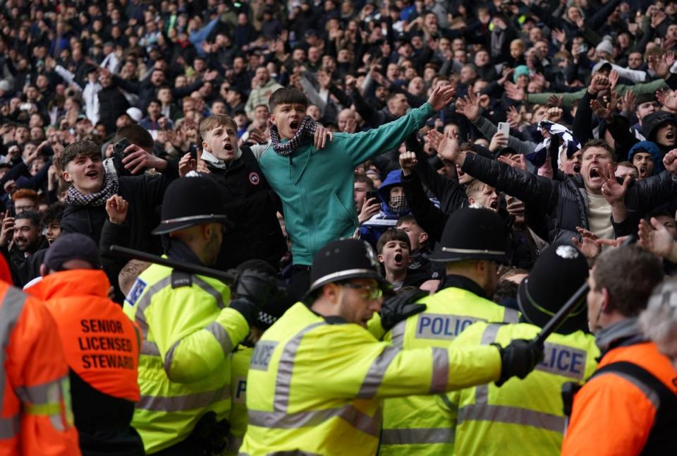 Fans invading the pitch clash with police officers (Bradley Collyer/PA Wire)