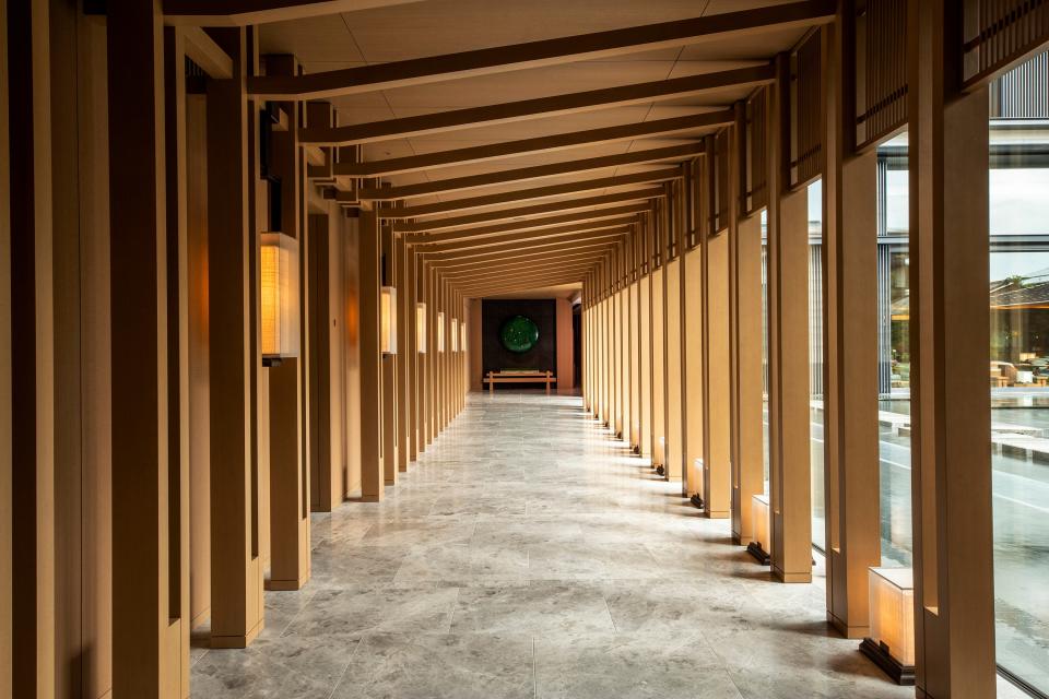 A long corridor evokes Kyoto's famous Fushimi Inari shrine.