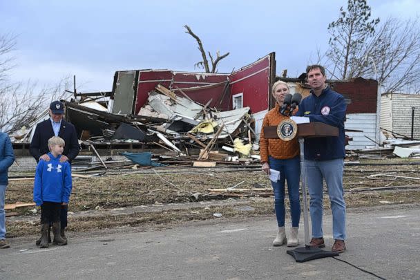 PHOTO: President Joe Biden stands with Dane Maddox, 7, Kentucky Governor Andy Beshear speaks next to Kentucky First Lady Britainy Beshear after touring storm damage in Dawson Springs, Ky., Dec. 15, 2021. (Brendan Smialowski/AFP via Getty Images)