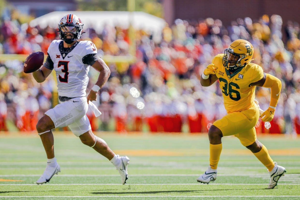 Oklahoma State quarterback Spencer Sanders (3) avoids Baylor linebacker Tyrone Brown (36) and looks to pass on Saturday, Oct. 1, 2022 in Waco, Texas. (AP Photo/Gareth Patterson)