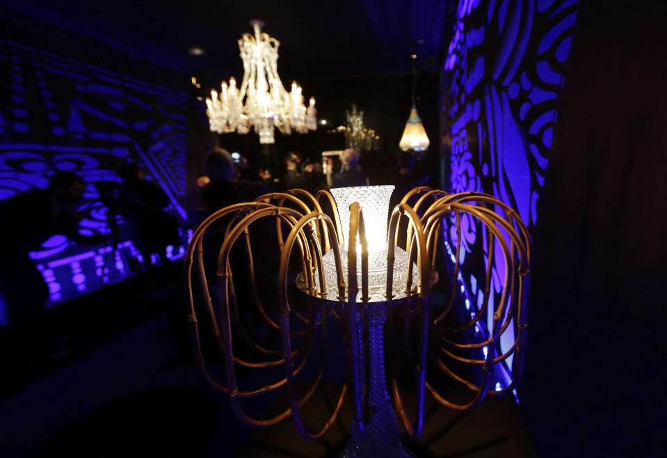 This rattan and crystal made lamp designed by Brazilian designers Fernando and Humberto Campana for Baccarat is displayed at Milan's Design Fair, in Milan, Italy, Thursday, April 11, 2013. The Milan furniture and design week fair, showcasing the latest in furniture and design from countries around the world, will continue until Sunday. (AP Photo/Luca Bruno)