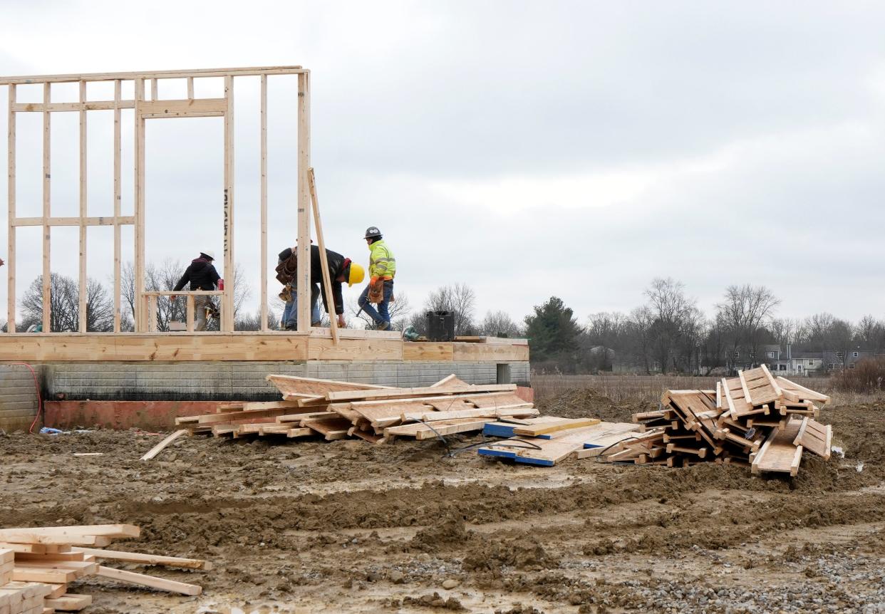 Workers build a home in the Spring Hill Farms neighborhood under development by M/I Homes in Reynoldsburg.