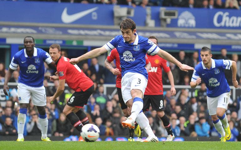 Everton's English defender Leighton Baines (C) scores his team's first goal from a penalty during the English Premier League football match between Everton and Manchester United at Goodison Park in Liverpool on April 20, 2014