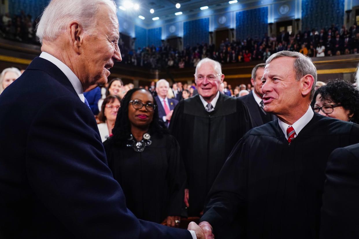 President Joe Biden greets Chief Justice of the Supreme Court John Roberts as he arrives to the House Chamber of the US Capitol for his third State of the Union address to a joint session of Congress at the U.S. Capitol in Washington on March 7, 2024.