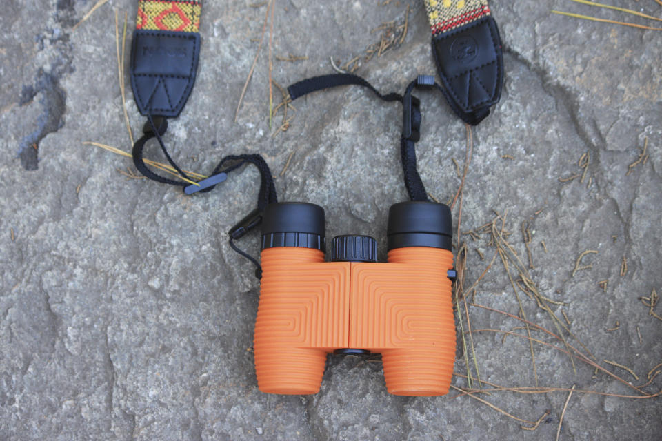 This photo provided by Nocs Provisions shows a pair of rugged binoculars. Experts recommend new birding enthusiasts opt for 8x magnification in their binoculars for ease of spotting. Nocs makes several colorful versions, with this Poppy Orange hue being the most popular. The bright colors also make the tool easy to find. (Nocs Provisions via AP)