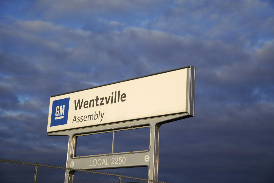 This March 24, 2021 photo shows a sign near an entrance to a General Motors assembly plant in Wentzville, Mo. Unionized auto workers in the U.S. will go back to wearing masks in all factories, offices and warehouses starting Wednesday, Aug. 4, because of the spreading delta coronavirus variant.(AP Photo/Jeff Roberson)