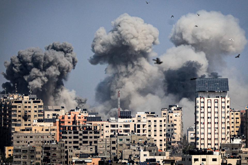 Smoke plumes billow during Israeli air strikes in Gaza City on October 12, 2023.