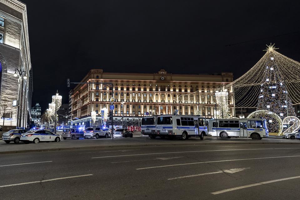 Police buses and cars block the area near the building of the Federal Security Service (FSB, Soviet KGB successor), right, in the background in Moscow, Russia, Thursday, Dec. 19, 2019. Russia's main security agency says shots have been fired near its headquarters in downtown Moscow. (AP Photo/Mikhail Kirakosyan)