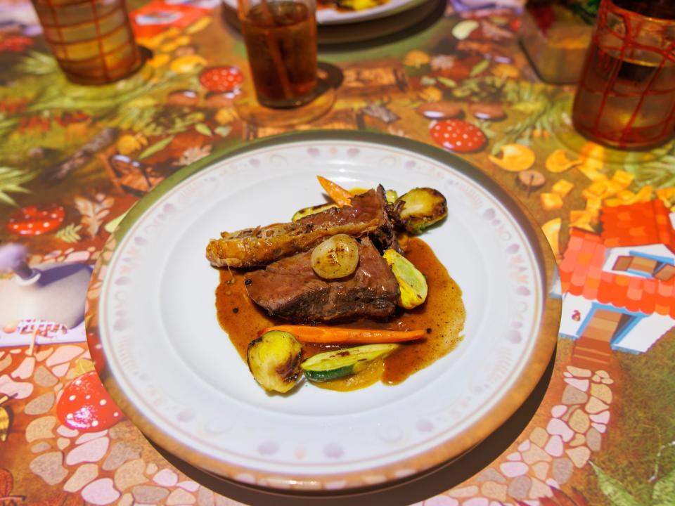 a plate of food on colorful table at la petit chef